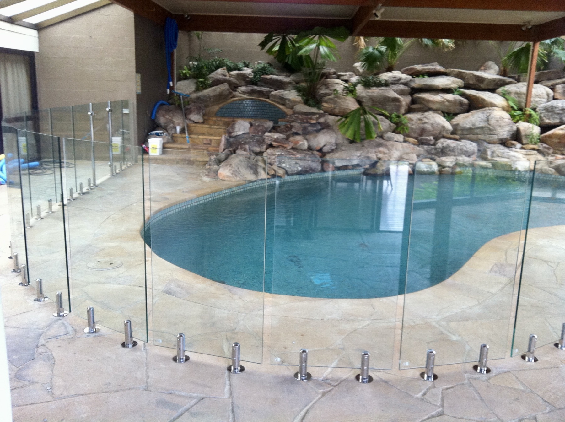 Glass pool fencing inside a screened pool enclosure